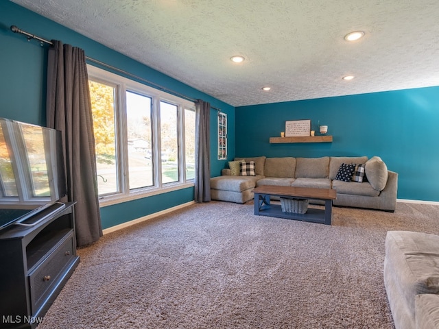 carpeted living room featuring a textured ceiling