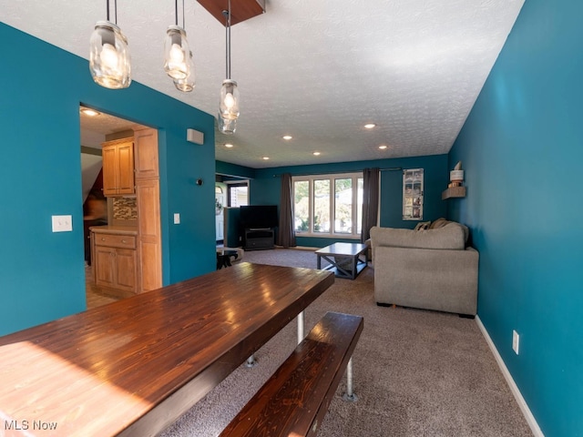 dining room with carpet floors and a textured ceiling