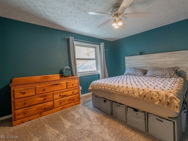 bedroom with carpet flooring, ceiling fan, and a textured ceiling