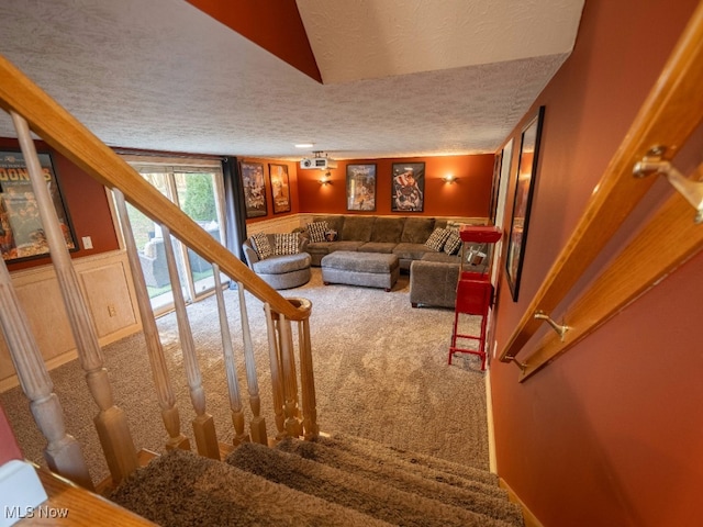 living room featuring carpet flooring and a textured ceiling