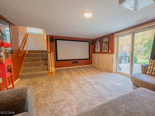 carpeted home theater with a textured ceiling