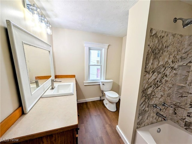 full bathroom with shower / bath combination, wood-type flooring, a textured ceiling, toilet, and vanity