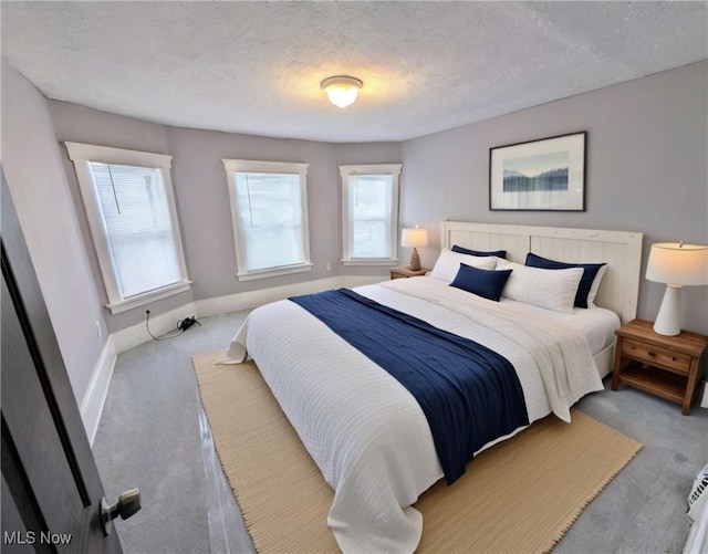 carpeted bedroom with a textured ceiling