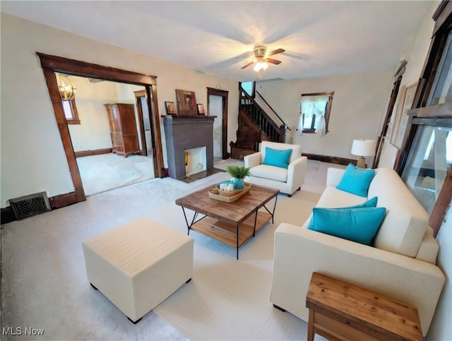 carpeted living room featuring ceiling fan and a brick fireplace