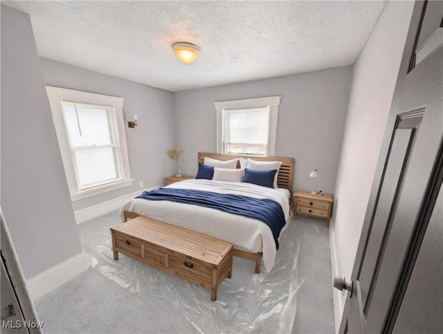 carpeted bedroom featuring a textured ceiling