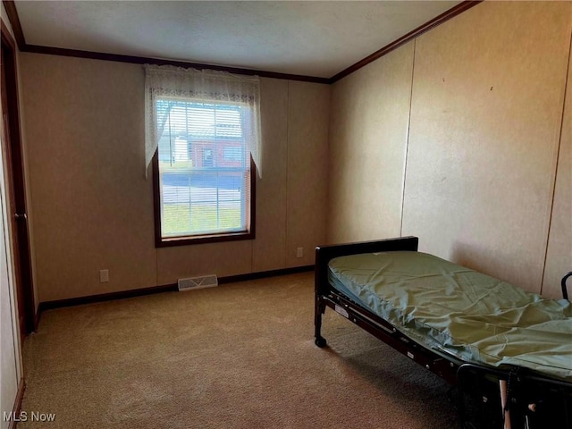 carpeted bedroom featuring crown molding