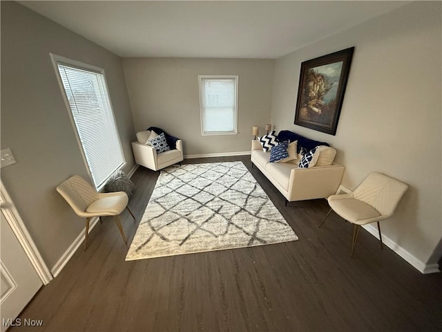 sitting room featuring a healthy amount of sunlight and dark hardwood / wood-style floors