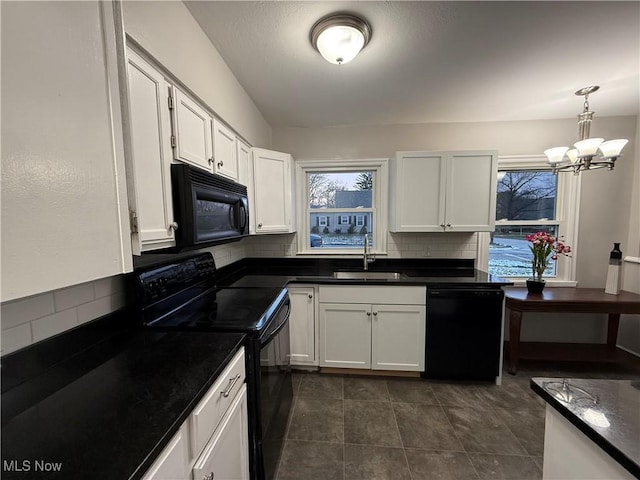 kitchen with black appliances, sink, hanging light fixtures, decorative backsplash, and white cabinetry