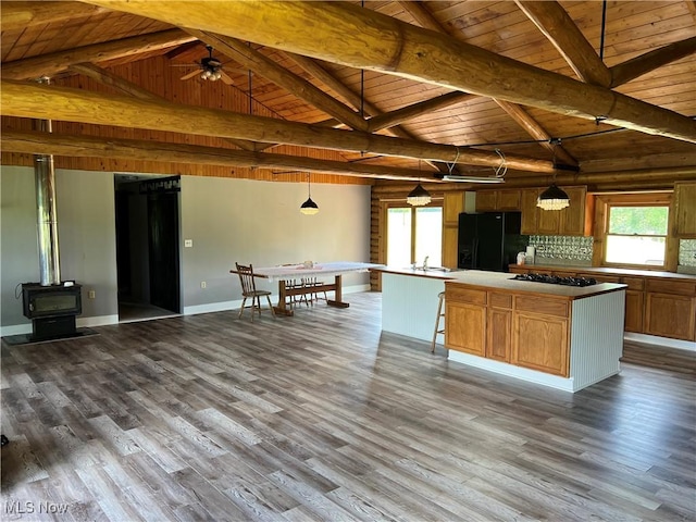 kitchen featuring black appliances, decorative light fixtures, a kitchen island, and wooden ceiling