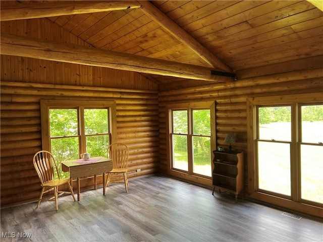 unfurnished sunroom featuring lofted ceiling with beams, a healthy amount of sunlight, and wooden ceiling