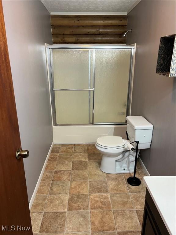 full bathroom featuring vanity, enclosed tub / shower combo, a textured ceiling, and toilet