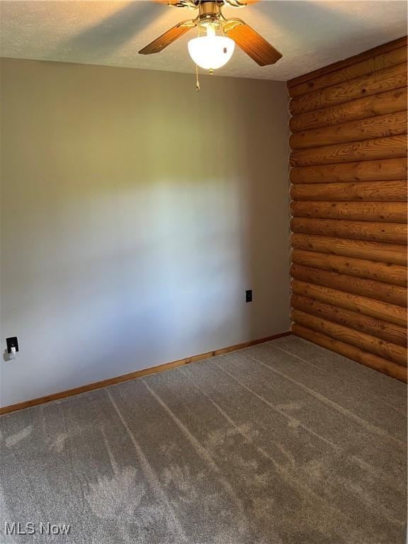 carpeted spare room with a textured ceiling