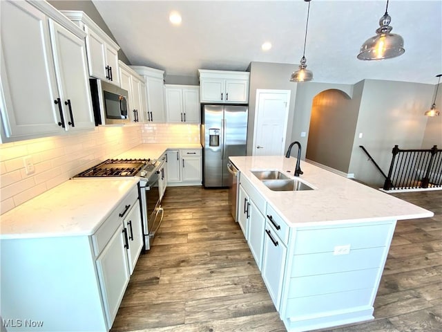 kitchen featuring white cabinets, pendant lighting, stainless steel appliances, and sink