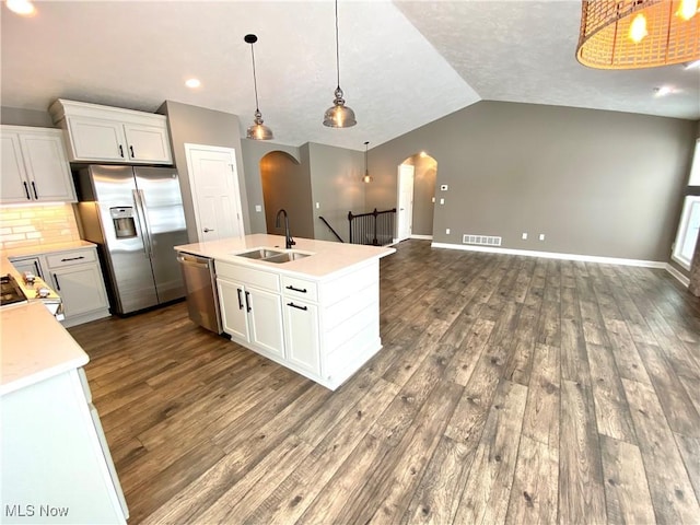 kitchen featuring hanging light fixtures, white cabinetry, sink, and stainless steel appliances