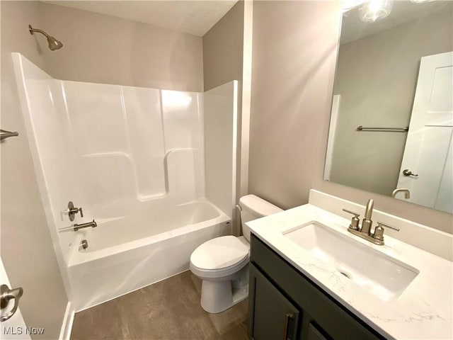 full bathroom with shower / tub combination, vanity, wood-type flooring, and toilet