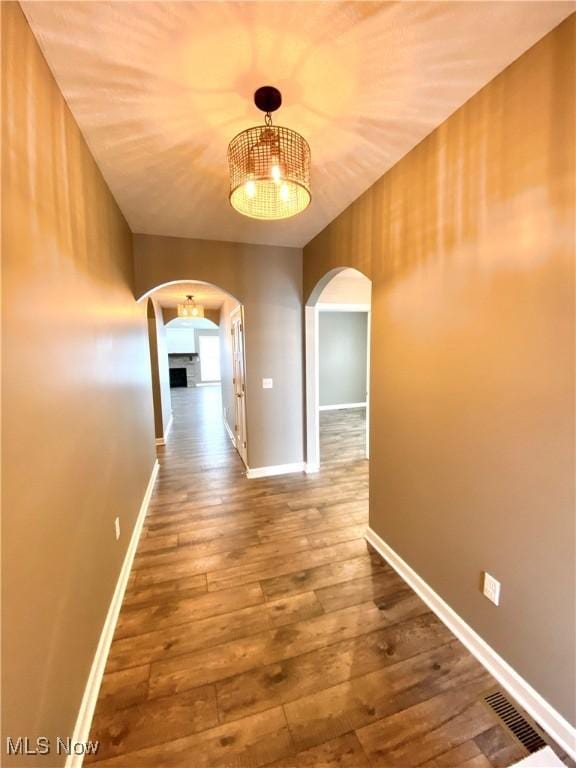 corridor with wood-type flooring