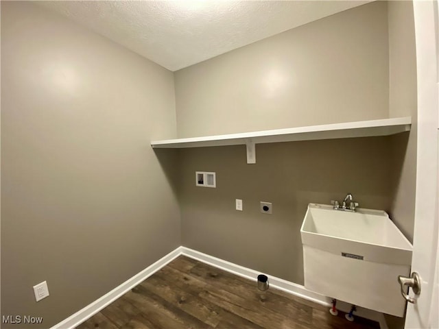 laundry room featuring sink, electric dryer hookup, dark hardwood / wood-style floors, hookup for a washing machine, and a textured ceiling