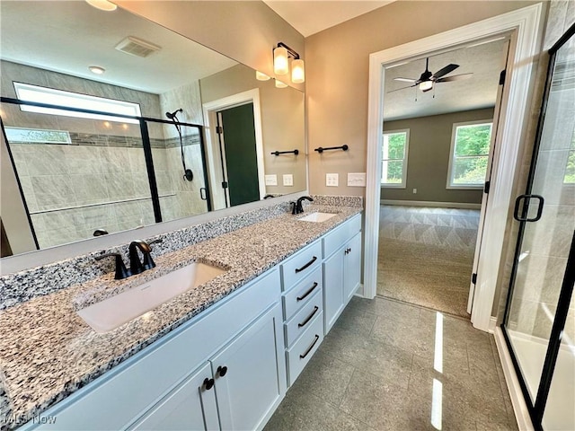 bathroom featuring walk in shower, vanity, and ceiling fan