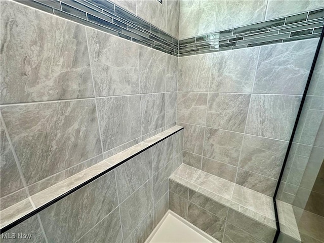 bathroom with a tile shower