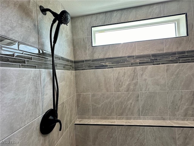 bathroom with a tile shower