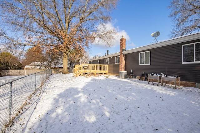 snowy yard with a wooden deck