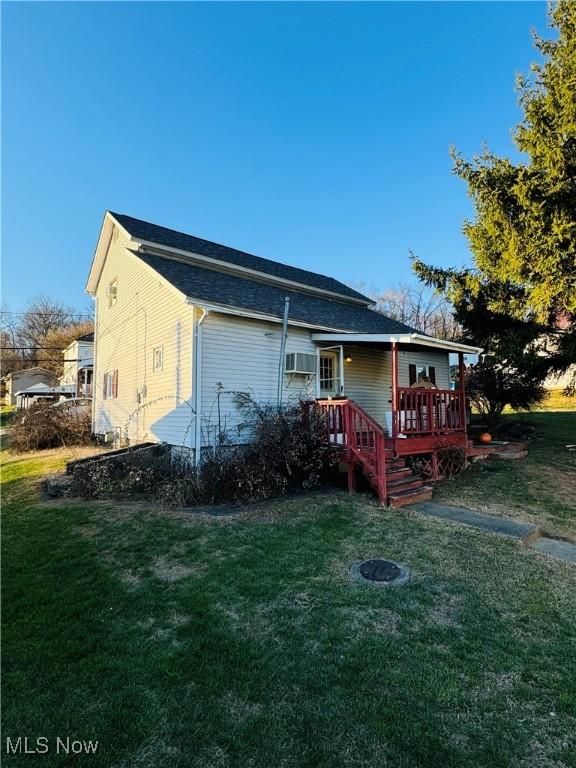 back of house with a yard and a deck