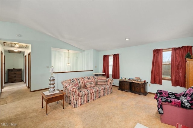 carpeted living room featuring vaulted ceiling