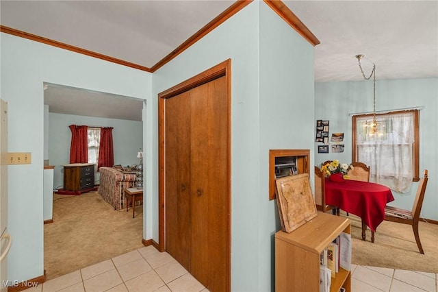 hall with a chandelier, crown molding, light colored carpet, and vaulted ceiling