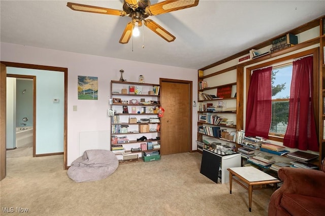 office area with light colored carpet and ceiling fan