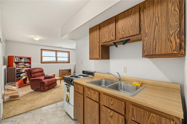 kitchen featuring white range with gas stovetop and sink