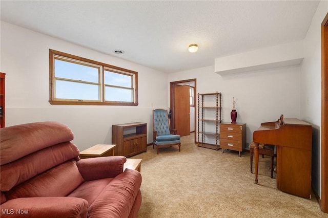 sitting room featuring light colored carpet