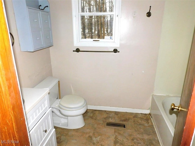 bathroom featuring vanity, toilet, and a bathtub