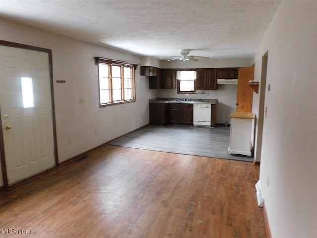 kitchen with dark brown cabinets, a textured ceiling, white dishwasher, ceiling fan, and wood-type flooring