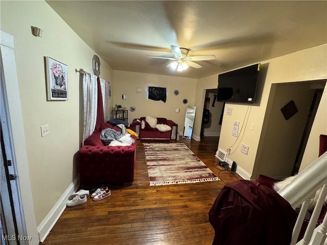 living room with ceiling fan and dark hardwood / wood-style floors