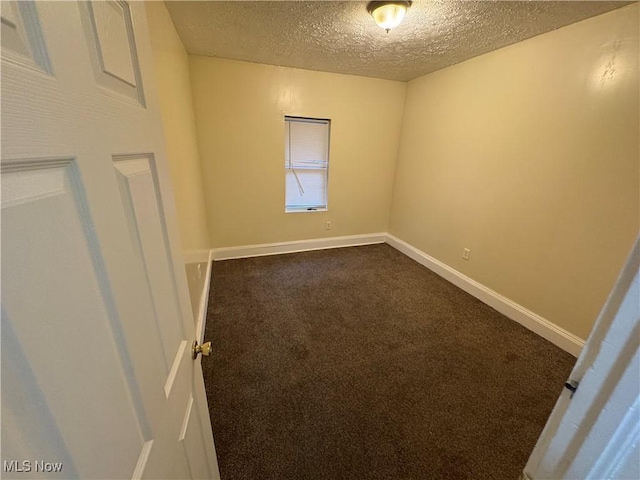 carpeted empty room with a textured ceiling