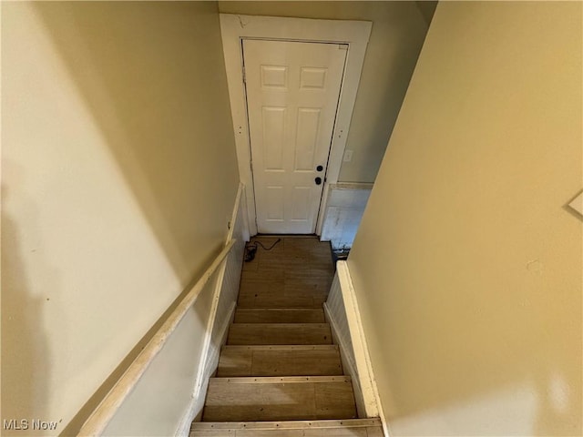 stairway with hardwood / wood-style flooring