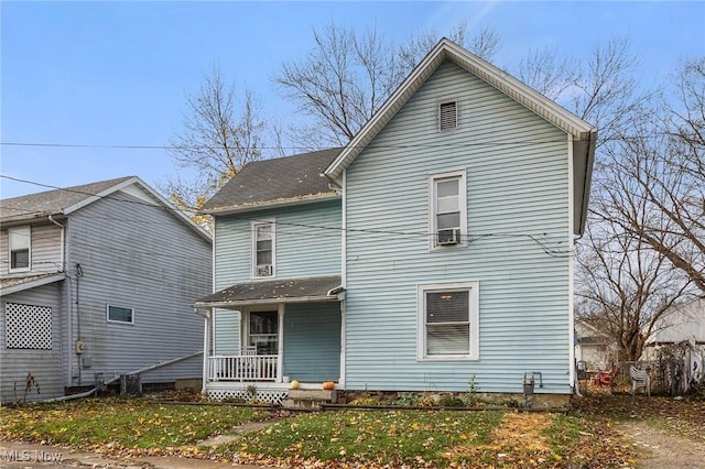 back of property featuring a yard and a porch