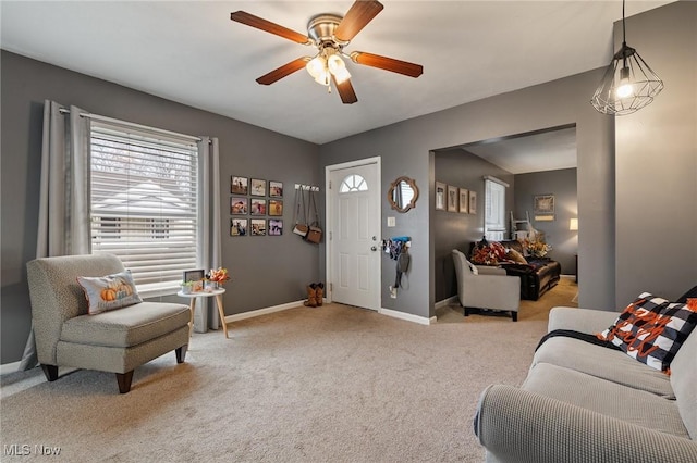 interior space with light carpet and ceiling fan