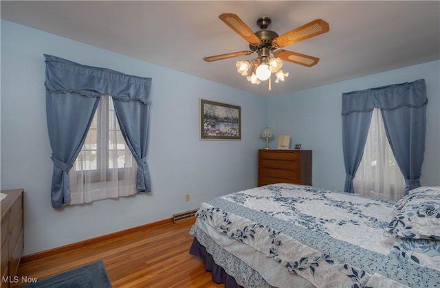 bedroom with ceiling fan and light hardwood / wood-style flooring