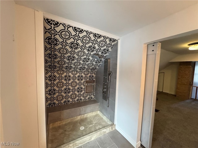 bathroom with tile patterned floors and tiled shower