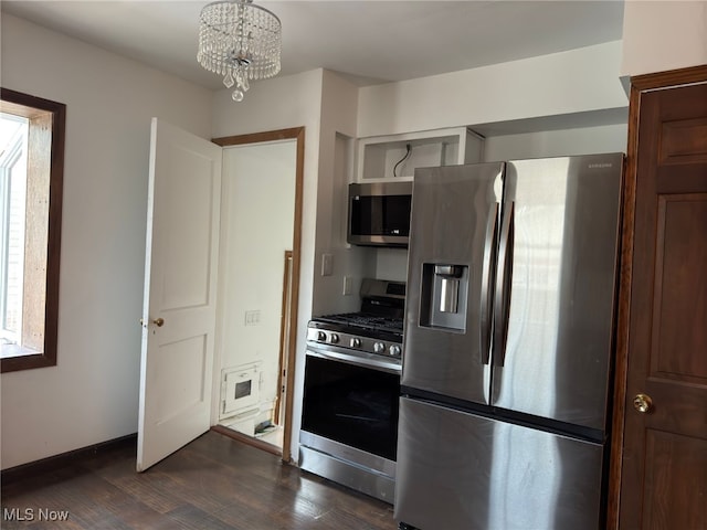 kitchen featuring appliances with stainless steel finishes, a chandelier, and dark hardwood / wood-style floors