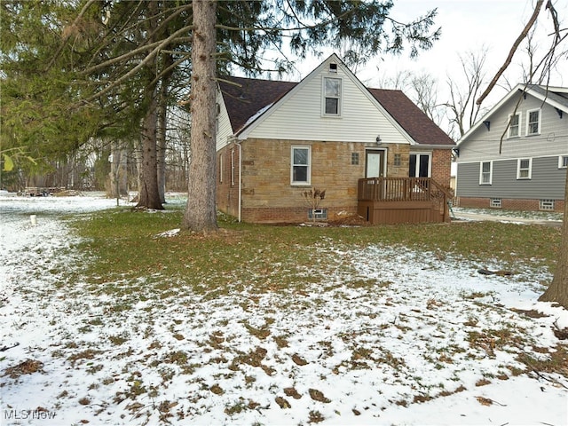 view of snow covered back of property