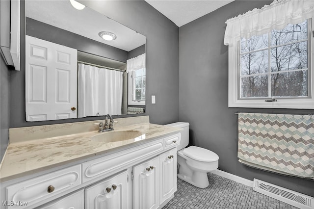 bathroom featuring tile patterned floors, vanity, and toilet