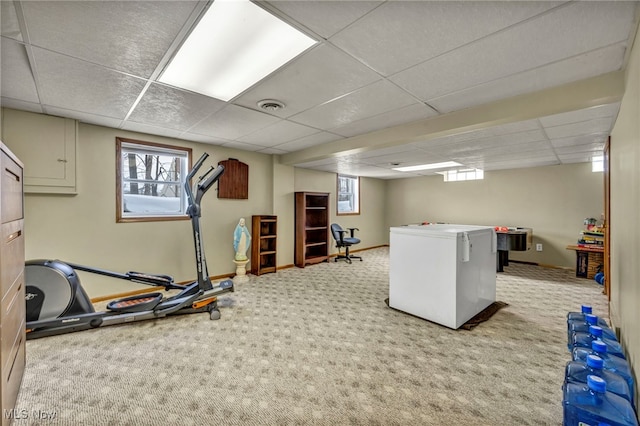 workout room with carpet and a paneled ceiling