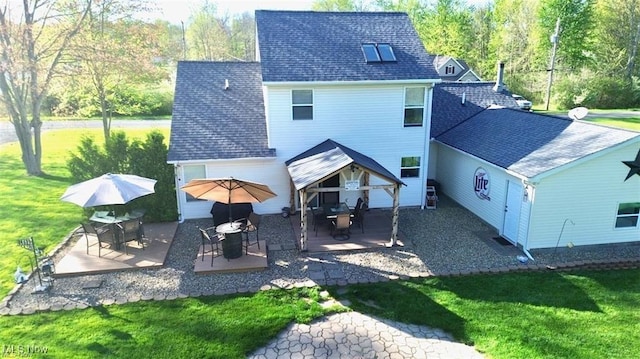 rear view of house featuring a yard and a patio