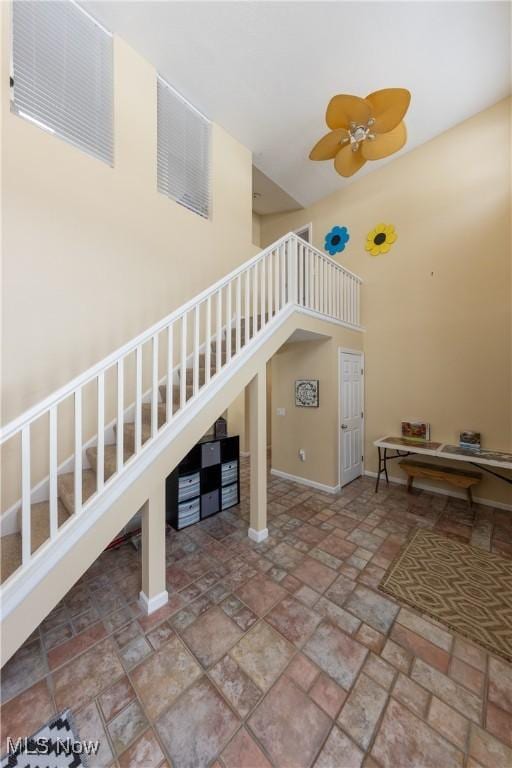 stairway with ceiling fan