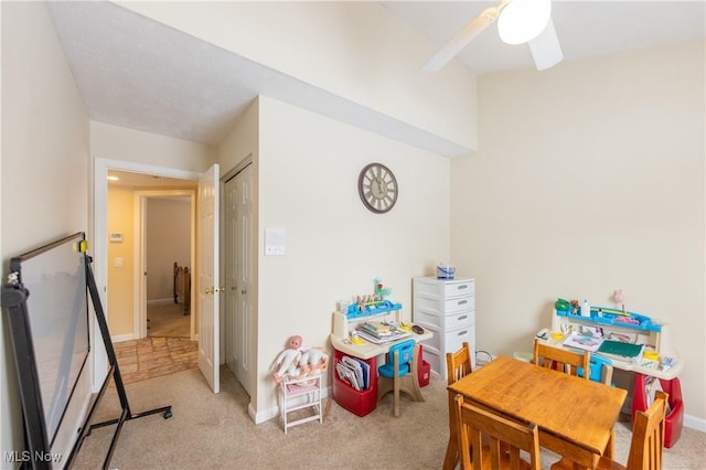 rec room with ceiling fan and light colored carpet