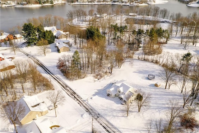 snowy aerial view featuring a water view