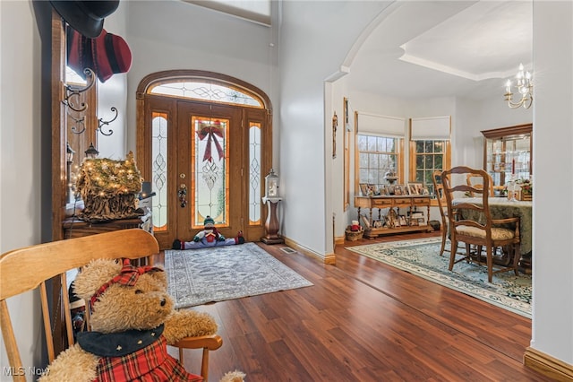 foyer featuring a chandelier and wood-type flooring