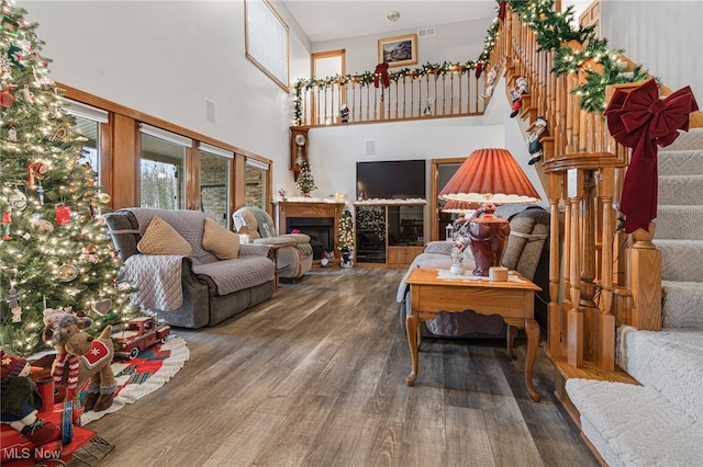 living room with a high ceiling and hardwood / wood-style flooring